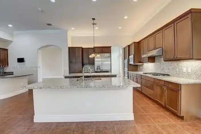 Triple-island chef kitchen with granite counters