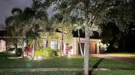 Property at night with landscape lighting